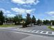 Community entrance gate with landscaping and signage providing a secure entry at 141 Mitchell Creek Way, Oviedo, FL 32765