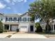Charming townhome featuring a one-car garage, blue shutters, and well-manicured landscaping at 141 Mitchell Creek Way, Oviedo, FL 32765