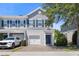 View of a townhome exterior featuring a one car garage, blue shutters, and a brick drive at 141 Mitchell Creek Way, Oviedo, FL 32765
