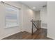 Upstairs hallway features wood flooring, neutral walls, window, and wood and metal banister at 141 Mitchell Creek Way, Oviedo, FL 32765