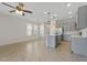 Bright kitchen featuring gray cabinets, stainless steel appliances, a kitchen island and decorative pendant lighting at 141 Mitchell Creek Way, Oviedo, FL 32765
