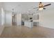 Open-concept kitchen with gray cabinets, stainless steel appliances, and a large island, tile floor and ceiling fans at 141 Mitchell Creek Way, Oviedo, FL 32765