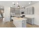 Modern kitchen featuring gray cabinets, stainless steel appliances, quartz countertops, and an island with a sink at 141 Mitchell Creek Way, Oviedo, FL 32765