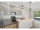 Modern kitchen features stainless appliances, gray cabinets, and center island with sink at 141 Mitchell Creek Way, Oviedo, FL 32765