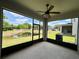 Relaxing screened-in patio with views of the backyard pond, offering a peaceful outdoor living space at 141 Mitchell Creek Way, Oviedo, FL 32765