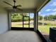 Enjoy the outdoors bug-free in this screened porch with ceiling fan and view of the pond at 141 Mitchell Creek Way, Oviedo, FL 32765