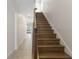 Wooden staircase leading upstairs, with decorative railings and a view into the home at 141 Mitchell Creek Way, Oviedo, FL 32765