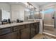Bathroom boasts dual sinks, granite countertops, a glass-enclosed shower, and ample cabinet space at 14131 Lakeview Park Rd, Winter Garden, FL 34787