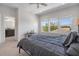 Bedroom featuring a view of lush backyard through three windows, soft carpet and natural light at 14131 Lakeview Park Rd, Winter Garden, FL 34787
