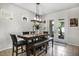 Bright dining area boasts natural light, a stylish light fixture, and access to the outdoor patio at 14131 Lakeview Park Rd, Winter Garden, FL 34787