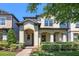 Charming two-story home featuring an inviting arched entryway and well-manicured landscaping at 14131 Lakeview Park Rd, Winter Garden, FL 34787