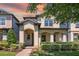 Charming two-story home featuring an inviting arched entryway and well-manicured landscaping at 14131 Lakeview Park Rd, Winter Garden, FL 34787