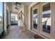 Covered patio with brick flooring, ceiling fans, and hanging hammock chair at 14131 Lakeview Park Rd, Winter Garden, FL 34787