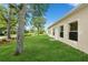 Spacious backyard features lush green lawn, mature shade trees, and attractive landscaping at 14208 Morning Frost Dr, Orlando, FL 32828