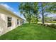 Lush green backyard with well-maintained lawn and mature trees at 14208 Morning Frost Dr, Orlando, FL 32828