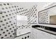 Modern bathroom with black and white tile, soaking tub, and updated vanity at 14208 Morning Frost Dr, Orlando, FL 32828