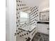 Modern bathroom with black and white tile, soaking tub, and updated vanity at 14208 Morning Frost Dr, Orlando, FL 32828