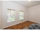 Bright bedroom with hardwood floors, natural light, and neutral paint at 14208 Morning Frost Dr, Orlando, FL 32828