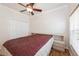Comfortable bedroom featuring a ceiling fan, wood floors, and a cozy bed with built in side tables at 14208 Morning Frost Dr, Orlando, FL 32828