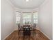 Bright dining area with natural light, wood-look flooring, a round table, and views of the outdoors at 14208 Morning Frost Dr, Orlando, FL 32828