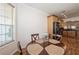 Charming dining area featuring natural light and wood-look flooring with an adjacent kitchen at 14208 Morning Frost Dr, Orlando, FL 32828
