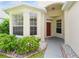Welcoming front entrance featuring a covered porch, large windows, and manicured landscaping that enhances curb appeal at 14208 Morning Frost Dr, Orlando, FL 32828