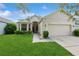 Charming home featuring a manicured front lawn and inviting curb appeal with a two car garage and well maintained landscaping at 14208 Morning Frost Dr, Orlando, FL 32828