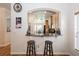 Open kitchen pass-through with breakfast bar and stool seating offering views into the dining and living areas at 14208 Morning Frost Dr, Orlando, FL 32828