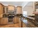 Beautiful kitchen featuring custom wood cabinetry, granite countertops, and stainless steel appliances for a modern design at 14208 Morning Frost Dr, Orlando, FL 32828