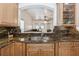 Kitchen sink and granite counters and wooden cabinetry offer tons of storage at 14208 Morning Frost Dr, Orlando, FL 32828