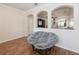 Bright living room featuring hardwood floors, archways, and large comfortable Papasan chair at 14208 Morning Frost Dr, Orlando, FL 32828