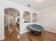Bright living room featuring hardwood floors, archways, and large comfortable Papasan chair at 14208 Morning Frost Dr, Orlando, FL 32828