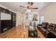 Spacious living room with hardwood floors, comfortable seating, access to the kitchen, and a ceiling fan at 14208 Morning Frost Dr, Orlando, FL 32828