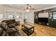 Open-concept living room with hardwood floors, comfortable seating, a ceiling fan, and access to other rooms at 14208 Morning Frost Dr, Orlando, FL 32828