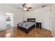 Spacious main bedroom with hardwood floors, ceiling fan, and ensuite bathroom access at 14208 Morning Frost Dr, Orlando, FL 32828