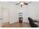 Spacious office with wood floors, ceiling fan, and built in shelving and desk space at 14208 Morning Frost Dr, Orlando, FL 32828