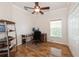 Bright office space with wood floors, ceiling fan, and a large window for natural light at 14208 Morning Frost Dr, Orlando, FL 32828