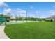 Well-maintained community tennis courts surrounded by lush greenery, perfect for recreation at 14208 Morning Frost Dr, Orlando, FL 32828