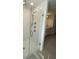 Modern shower showcases sleek tile work and a frameless glass enclosure for a luxurious experience at 14746 Erice Ave, Clermont, FL 34714