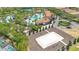 Beautiful aerial view featuring a volleyball court, pool, and lounge areas with clubhouse at 1504 Oak Marsh Loop, Davenport, FL 33837