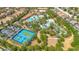 Aerial view of a community offering pools, club house, lazy river and a tennis court at 1504 Oak Marsh Loop, Davenport, FL 33837