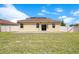 Home boasts a large, fully-fenced backyard with an open patio perfect for outdoor entertaining at 1504 Oak Marsh Loop, Davenport, FL 33837