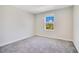 Bedroom featuring neutral carpet, a window, and white walls at 1504 Oak Marsh Loop, Davenport, FL 33837
