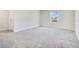 Bedroom with gray carpet, white walls and a window at 1504 Oak Marsh Loop, Davenport, FL 33837