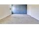 Bedroom featuring a blue accent wall, gray carpeting and a window at 1504 Oak Marsh Loop, Davenport, FL 33837