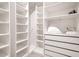 A spacious walk-in closet boasts generous shelving and drawer space for optimal organization at 1504 Oak Marsh Loop, Davenport, FL 33837