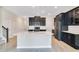 Kitchen with dark cabinets, white countertops, and a large kitchen island with a sink at 1504 Oak Marsh Loop, Davenport, FL 33837