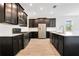 Kitchen with dark cabinets, stainless steel appliances, white countertops, and light wood-look tile flooring at 1504 Oak Marsh Loop, Davenport, FL 33837