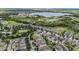 Aerial view of the community featuring lush landscaping, a lake, and a tennis court at 15849 Sweet Lemon Way, Winter Garden, FL 34787