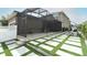 Backyard with a screened-in patio featuring a cooking area and patio with modern pavers and artificial grass at 15849 Sweet Lemon Way, Winter Garden, FL 34787